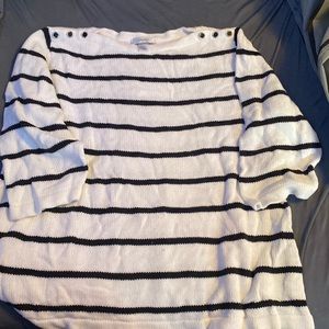 A white and black cj banks sweater with buttons around the collar bone